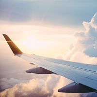 airplane wing over clouds